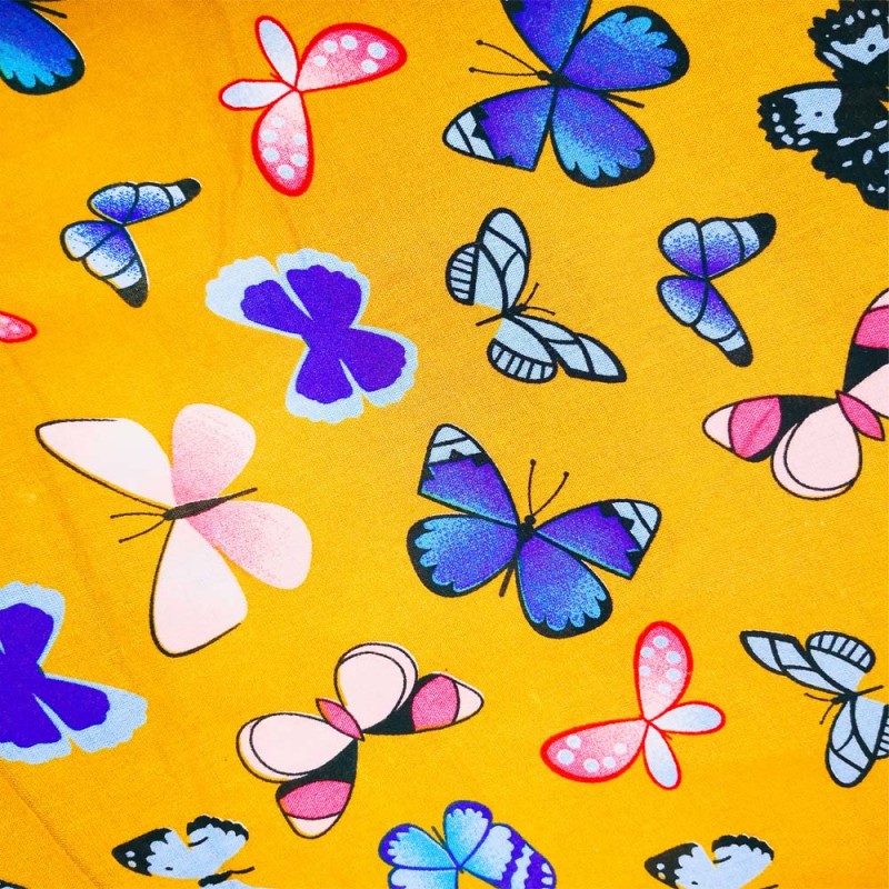 Tissu Viscose imprimée de papillons multicolores sur un fond jaune. Tissu Viscose imprimée de papillons multicolores sur un fond jaune.